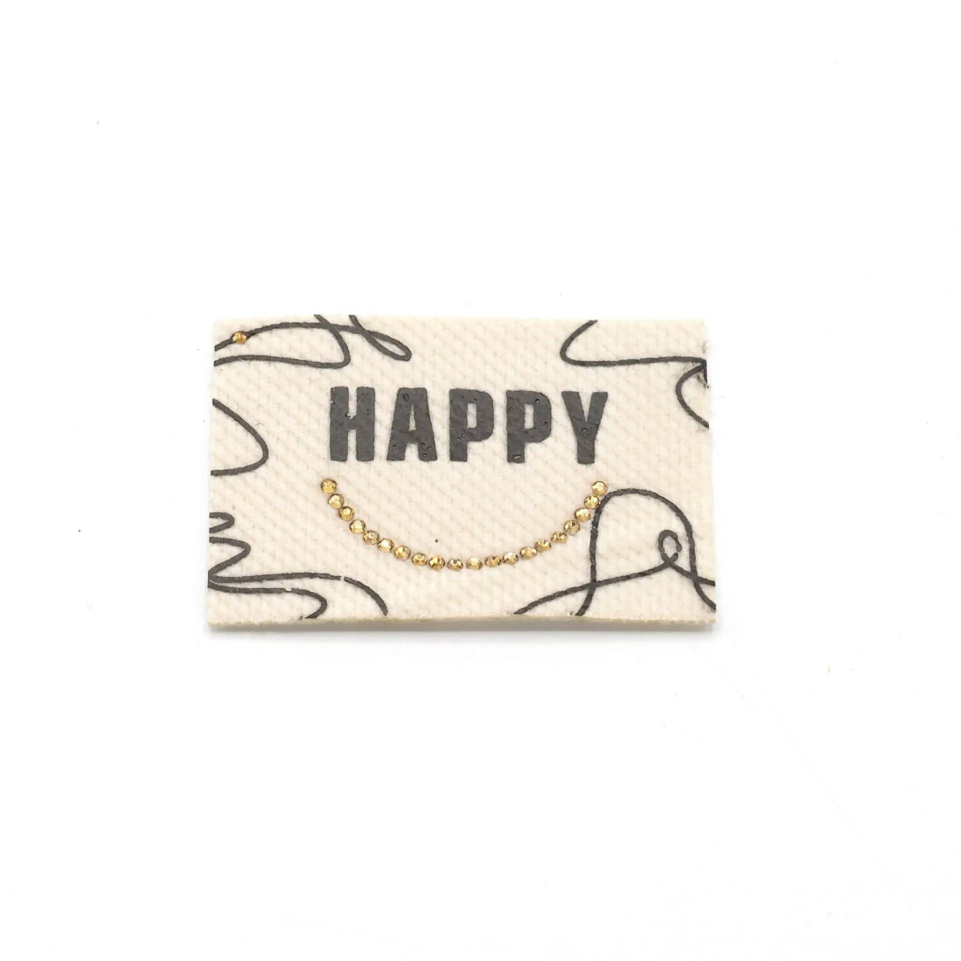 Aufbügelbares Webetikett Happy, ecru von Stoffe Hemmers