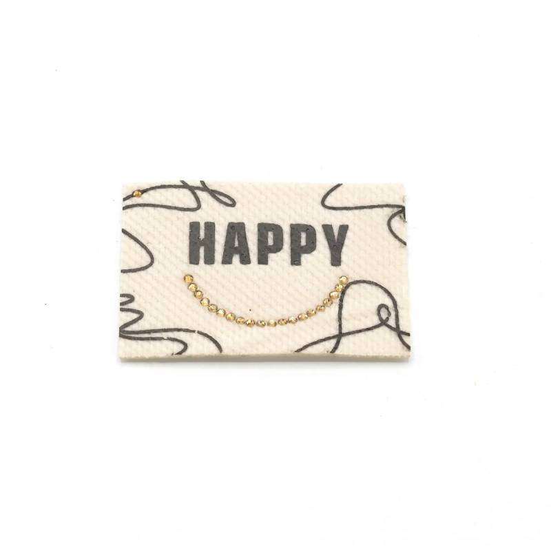 Aufbügelbares Webetikett Happy, ecru von Stoffe Hemmers