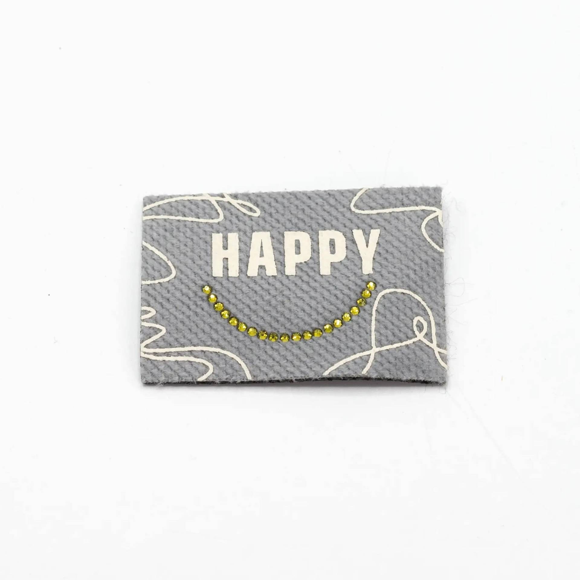 Aufbügelbares Webetikett Happy, hellgrau von Stoffe Hemmers